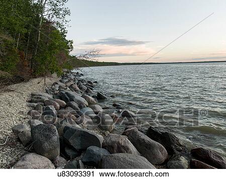 Stock Image - Rocks along shoreline, Lake Winnipeg, Riverton, Hecla Grindstone Provincial Park, Manitoba, Canada. Fotosearch