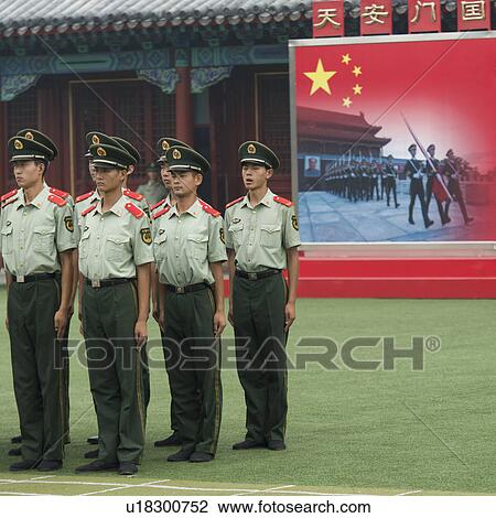 Stock Image - Security guards standing in front of a building, Xicheng District, Beijing, China. Fotosearch