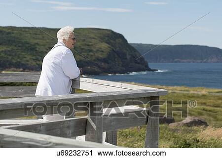 Senior woman looking at ocean view, Cape Spear, St. John's, Newfoundland And Labrador, Canada View Large Photo Image Stock Image - Senior woman looking at ocean view, Cape Spear, St. John's, Newfoundland And Labrador, Canada. Fotosearch