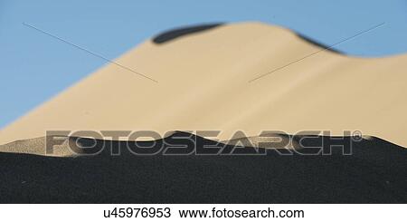 Stock Image - Singing sand dunes at Mingsha Shan, Gobi Desert, Dunhuang, Jiuquan, Gansu Province, China. Fotosearch