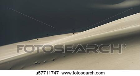 Stock Photo - Singing sand dunes at Mingsha Shan, Gobi Desert, Dunhuang, Jiuquan, Gansu Province, China. Fotosearch
