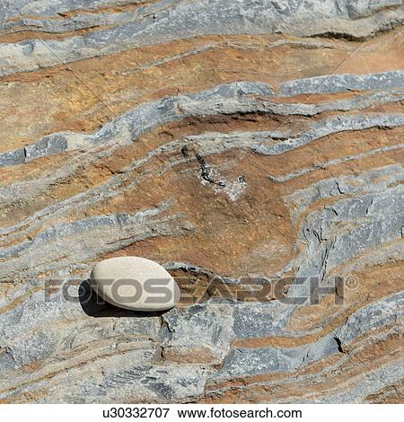 Stock Photo - Small pebble on sandstone rock, Wild Cove, Norris Point, Gros Morne National Park, Newfoundland And Labrador, Canada. Fotosearch