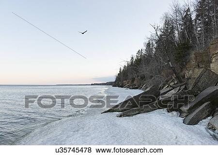 Stock Photo - Snow at the lakeside, Lake Winnipeg, Hecla Grindstone Provincial Park, Manitoba, Canada. Fotosearch