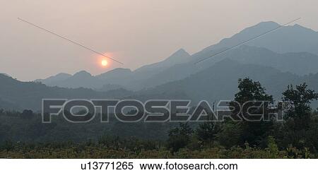 Stock Photography - Sunrise over mountain range viewed from Great Wall Of China, Jinshanling, Beijing, China. Fotosearch