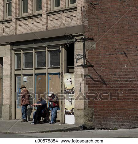 Picture - Three men standing in front of a derelict building on street, Seattle, Washington State, USA. Fotosearch