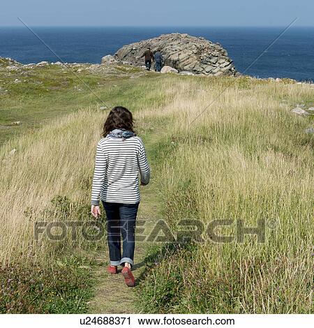 Stock Image - Tourists at coast, Bonavista Peninsula, Newfoundland And Labrador, Canada. Fotosearch