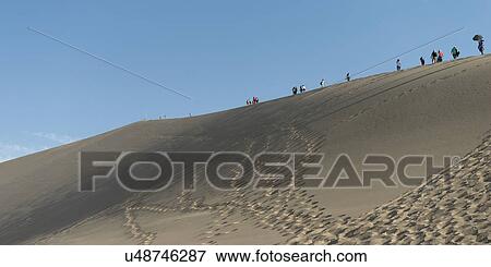Tourists at Mingsha Shan, Dunhuang, Jiuquan, Gansu Province, China View Large Photo Image Stock Photo - Tourists at Mingsha Shan, Dunhuang, Jiuquan, Gansu Province, China. Fotosearch