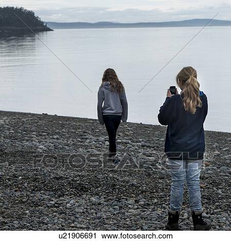 Stock Image - Tourists at the lakeside, Deception Pass State Park, Oak Harbor, Washington State, USA. Fotosearch