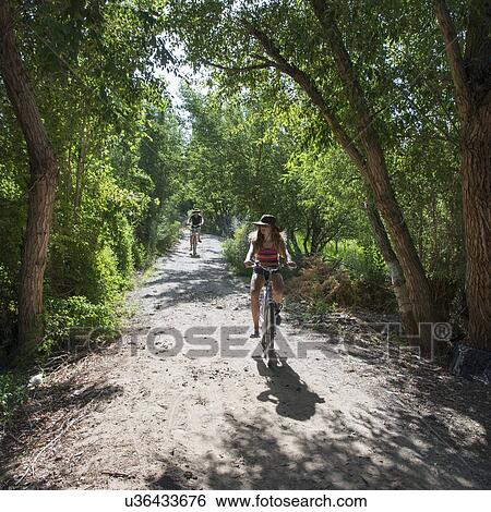Tourists riding bicycles on dirt road, Dunhuang, Jiuquan, Gansu Province, China View Large Photo Image Stock Photograph - Tourists riding bicycles on dirt road, Dunhuang, Jiuquan, Gansu Province, China. Fotosearch