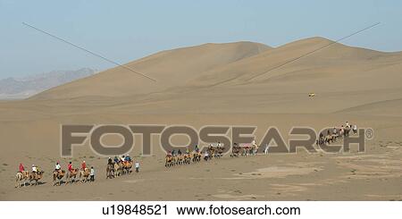 Tourists riding camels at Mingsha Shan, Dunhuang, Jiuquan, Gansu Province, China View Large Photo Image Stock Image - Tourists riding camels at Mingsha Shan, Dunhuang, Jiuquan, Gansu Province, China. Fotosearch