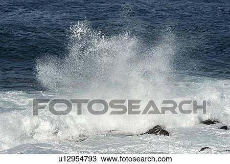 Stock Image - Waves breaking on the beach, Cape Spear, St. John's, Newfoundland And Labrador, Canada. Fotosearch