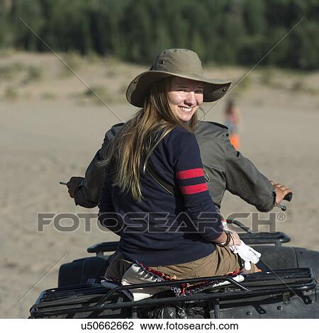 Woman enjoying quadbike ride in desert at Mingsha Shan, Dunhuang, Jiuquan, Gansu Province, China View Large Photo Image Stock Image - Woman enjoying quadbike ride in desert at Mingsha Shan, Dunhuang, Jiuquan, Gansu Province, China. Fotosearch