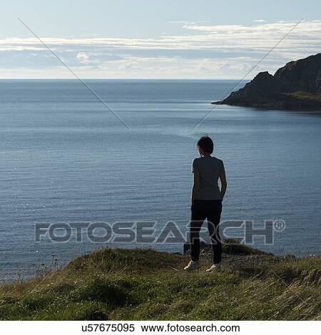 Woman looking at ocean view on the coast, North Twillingate Island, Newfoundland And Labrador, Canada View Large Photo Image Stock Photography - Woman looking at ocean view on the coast, North Twillingate Island, Newfoundland And Labrador, Canada. Fotosearch