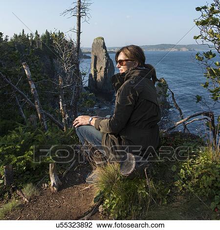 Woman sitting along Skerwink Trail, Port Rexton, Bonavista Peninsula, Newfoundland And Labrador, Canada View Large Photo Image Stock Image - Woman sitting along Skerwink Trail, Port Rexton, Bonavista Peninsula, Newfoundland And Labrador, Canada. Fotosearch