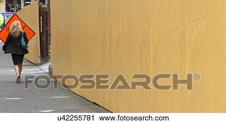 Stock Image - Woman walking on the street, Seattle, Washington State, USA. Fotosearch
