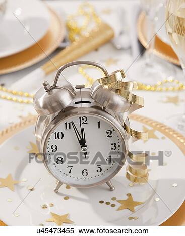 Stock Photography - Alarm clock with ribbons on plate. Fotosearch