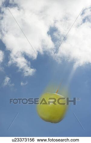 Stock Photograph - Apple falling out of sky. Fotosearch