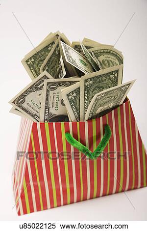 Bag of one dollar bills, studio shot View Large Photo Image Stock Photography - Bag of one dollar bills, studio shot. Fotosearch