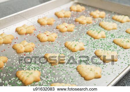 Stock Image - Baked spritz cookies on baking sheet. Fotosearch