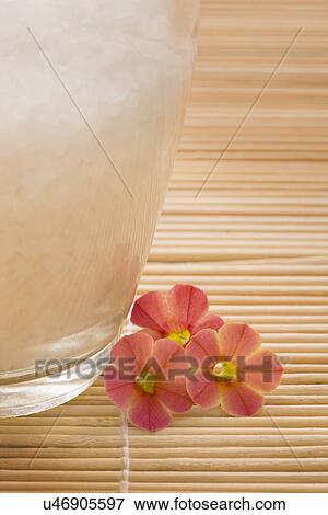 Stock Photo - Bath salt and flowers on bamboo mat. Fotosearch