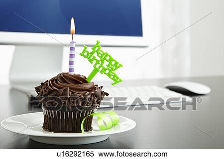 Birthday cupcake on desk View Large Photo Image Stock Photography - Birthday cupcake on desk. Fotosearch