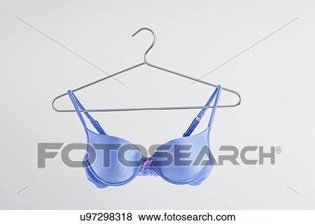 Stock Photo - Blue bra on hanger, studio shot. Fotosearch