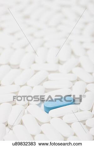 Blue pill among white pills, studio shot View Large Photo Image Stock Image - Blue pill among white pills, studio shot. Fotosearch