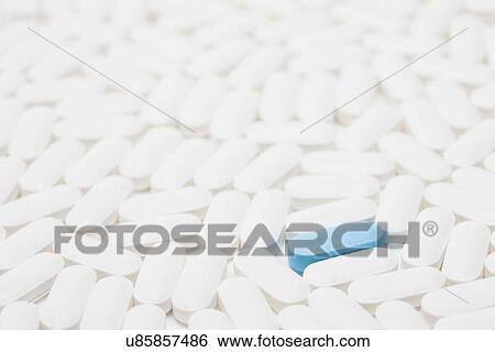 Blue pill among white pills, studio shot View Large Photo Image Stock Photograph - Blue pill among white pills, studio shot. Fotosearch