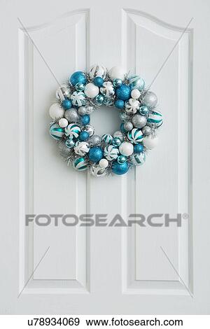 Blue wreath hanging on white door View Large Photo Image Stock Photo - Blue wreath hanging on white door. Fotosearch