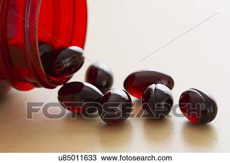 Stock Image - Bottle of Vitamins, Gel capsules. Fotosearch