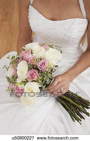 Bride holding bouquet View Large Photo Image Stock Photo - Bride holding bouquet. Fotosearch