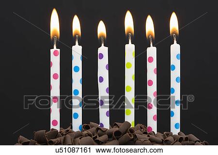 Stock Image - Burning candles on cake. Fotosearch