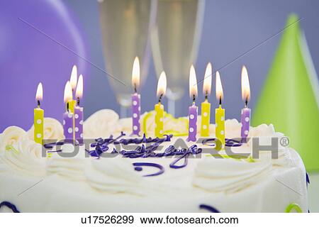 Stock Photo - Burning candles on cake. Fotosearch