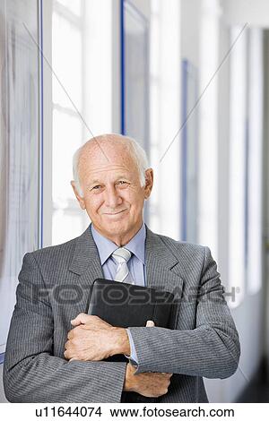 Picture - Businessman holding briefcase, portrait. Fotosearch