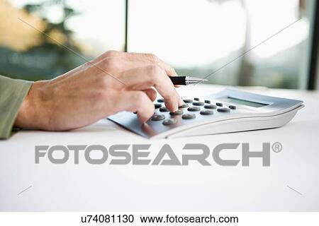 Businessman using calculator, close-up View Large Photo Image Stock Image - Businessman using calculator, close-up. Fotosearch