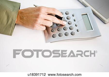 Businessman using calculator, elevated view View Large Photo Image Stock Image - Businessman using calculator, elevated view. Fotosearch