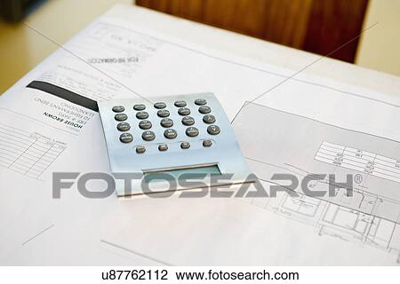 Stock Image - Calculator on blueprint. Fotosearch