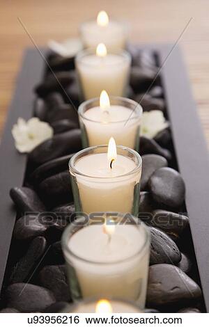 Stock Photograph - Candles and stones in spa, Studio Shot. Fotosearch