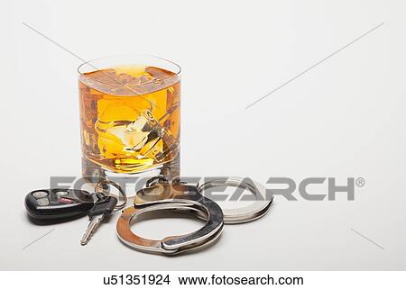 Picture - Car key, handcuffs and glass of whiskey. Fotosearch