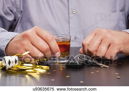 Car keys lying next to man holding glass of whiskey View Large Photo Image Stock Photography - Car keys lying next to man holding glass of whiskey. Fotosearch