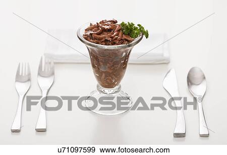 Stock Photo - Cat food in elegant glass garnished with parsley. Fotosearch