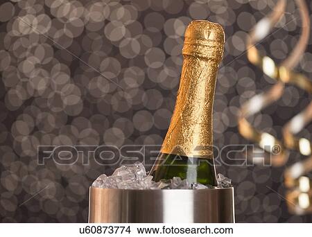 Picture - Champagne bottle in ice bucket. Fotosearch
