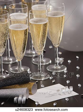 Stock Image - Champagne flutes on table. Fotosearch