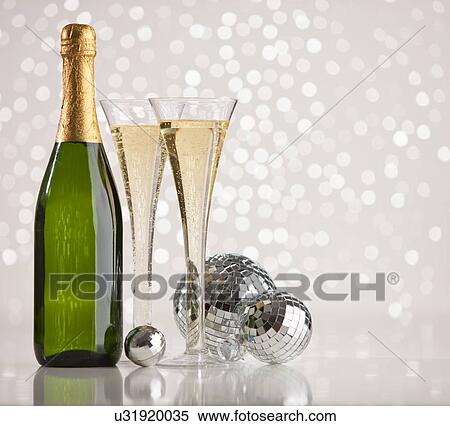Stock Photography - Champagne glass and bottle and disco balls. Fotosearch