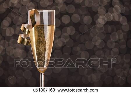 Champagne glass with golden ribbon View Large Photo Image Stock Photo - Champagne glass with golden ribbon. Fotosearch