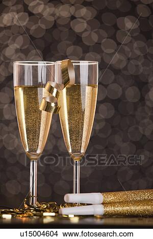 Champagne glasses and party horns View Large Photo Image Picture - Champagne glasses and party horns. Fotosearch