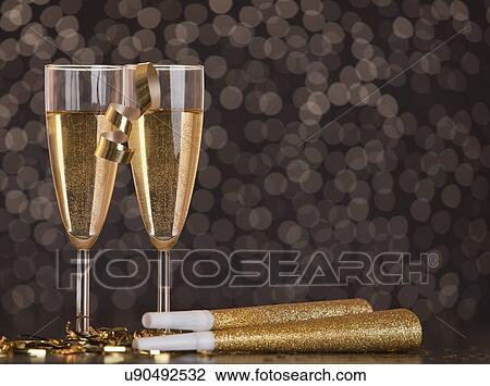 Champagne glasses and party horns View Large Photo Image Stock Image - Champagne glasses and party horns. Fotosearch