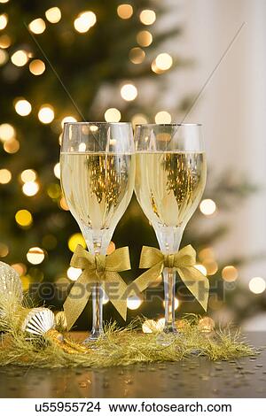 Champagne in front of Christmas tree View Large Photo Image Picture - Champagne in front of Christmas tree. Fotosearch