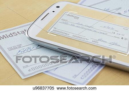 Cheque and cell phone lying on table View Large Photo Image Stock Photography - Cheque and cell phone lying on table. Fotosearch
