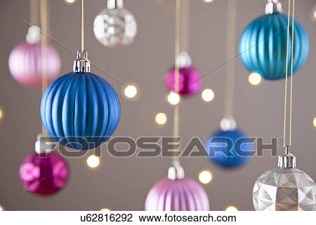 Christmas baubles hanging, studio shot View Large Photo Image Stock Image - Christmas baubles hanging, studio shot. Fotosearch